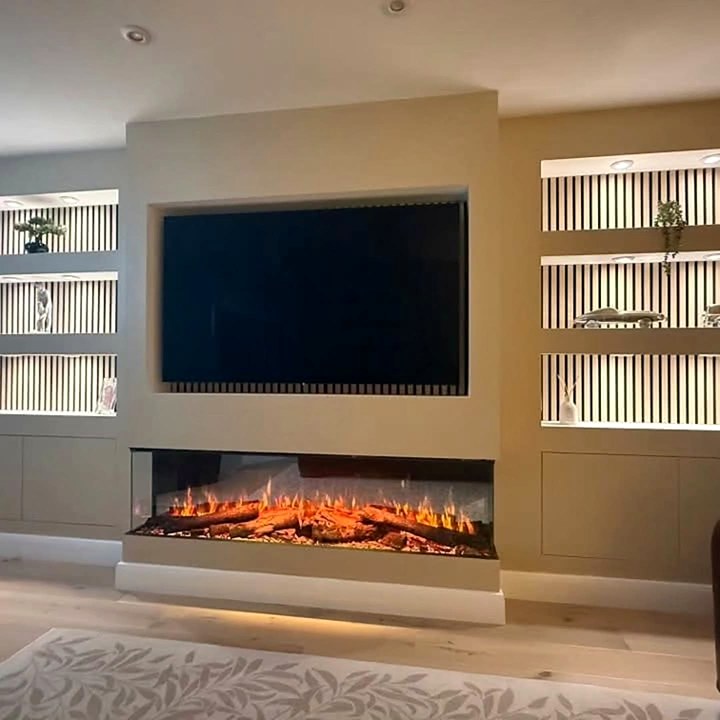 Media wall with an inset electric fire, TV recess and LED-lit shelving with slatted backs